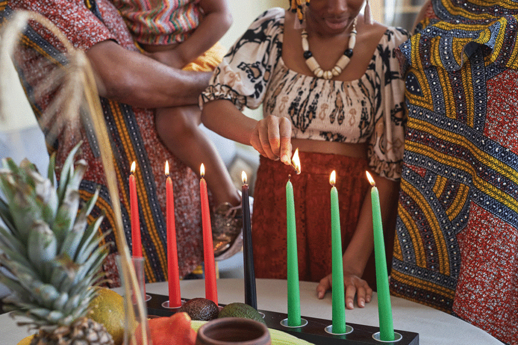 Family Celebrating Kwanzaa By Lighting A Kinara