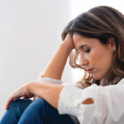 A Woman In A White Blouse Sitting And Resting