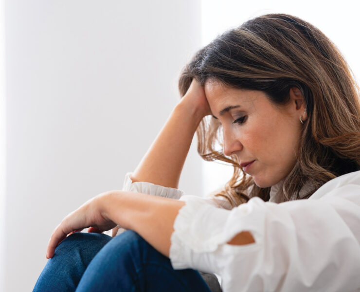 A Woman In A White Blouse Sitting And Resting