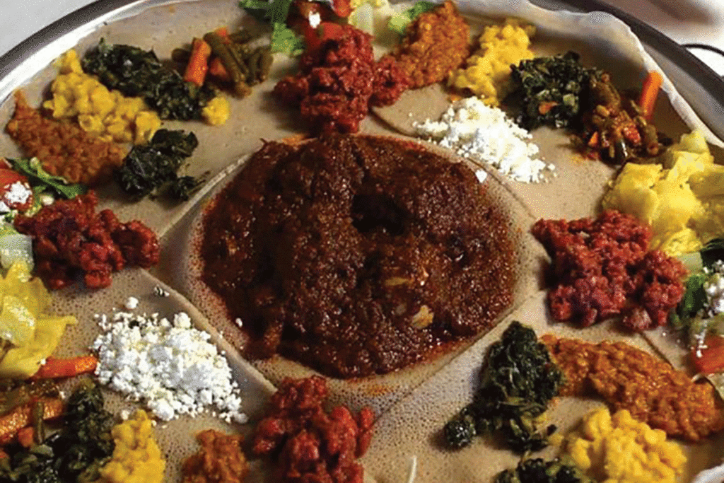 Injera covered in a sampling of Ethiopian dishes from Mahis Ethiopian Kitchen in Columbia, Missouri.