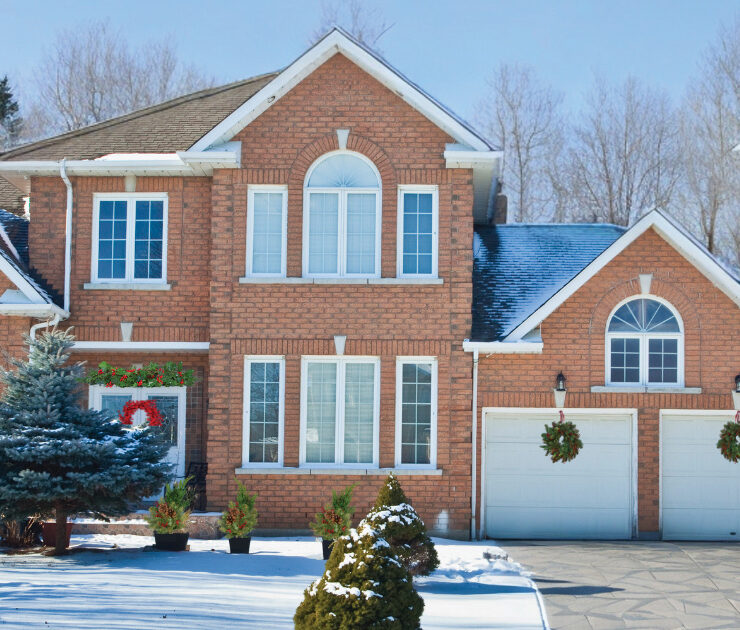 Bev And Co Exterior Of A Brick Home In The Snow Decorated For The Holidays