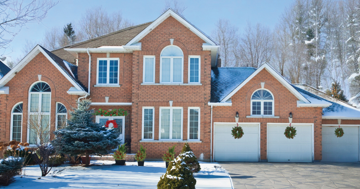 Bev And Co Exterior Of A Brick Home In The Snow Decorated For The Holidays