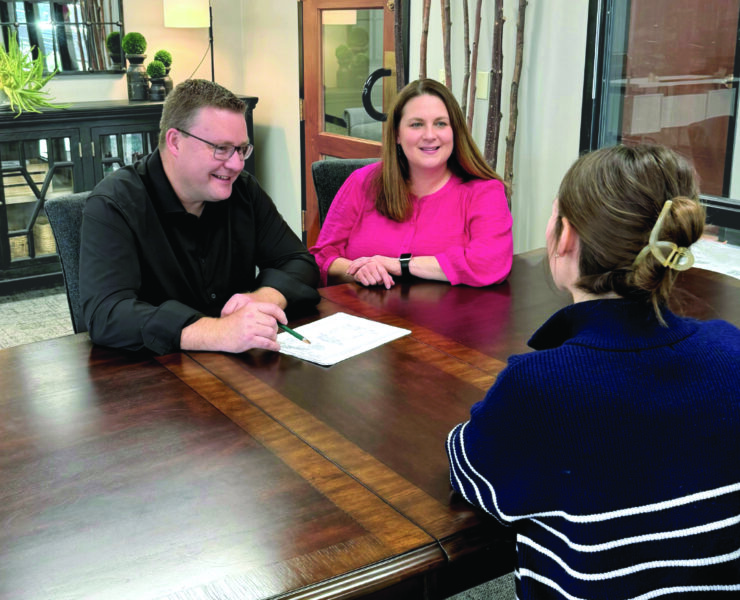 Geoff and Krista Jones sitting across from a client.