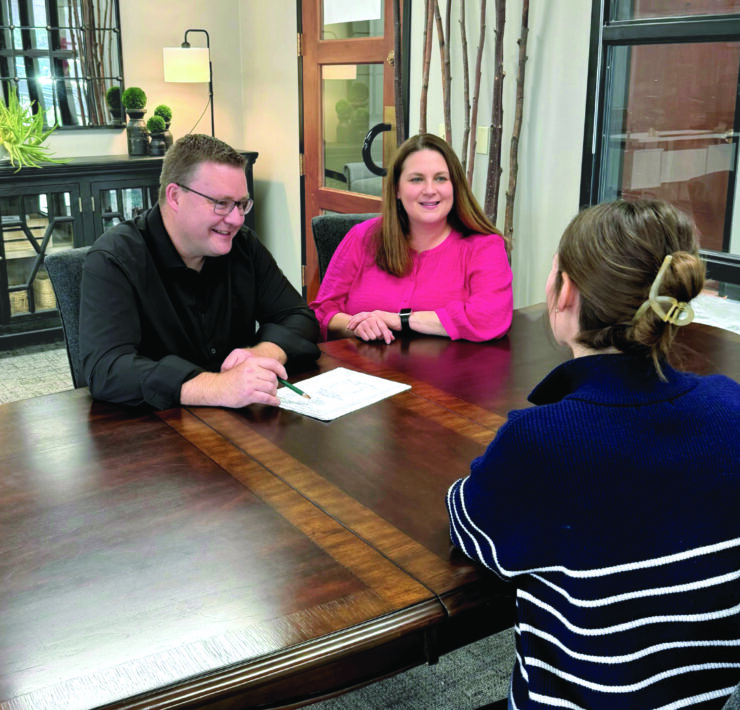 Geoff and Krista Jones sitting across from a client.