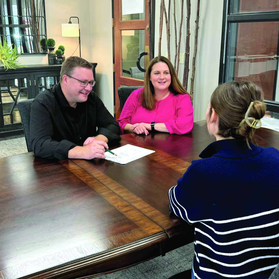 Geoff and Krista Jones sitting across from a client.