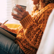 Featured Woman Writing In A Journal While Drinking Coffee