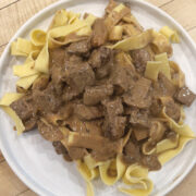 A Plate Of Prepared Beef Stroganoff Over Egg Noodles