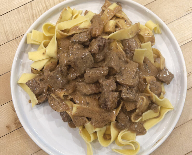 A Plate Of Prepared Beef Stroganoff Over Egg Noodles