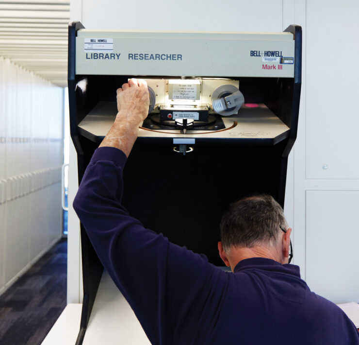 Featured A Researcher Using A Microfilm Machine