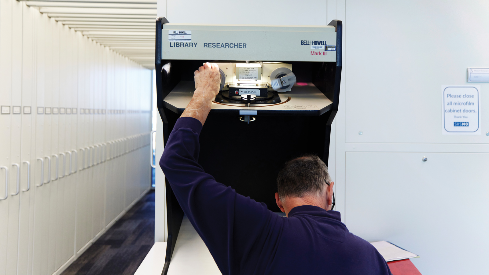 Featured A Researcher Using A Microfilm Machine