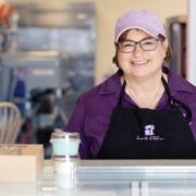 Featured Owner Of Jowins Jean Nicklas Poses Behind Counter