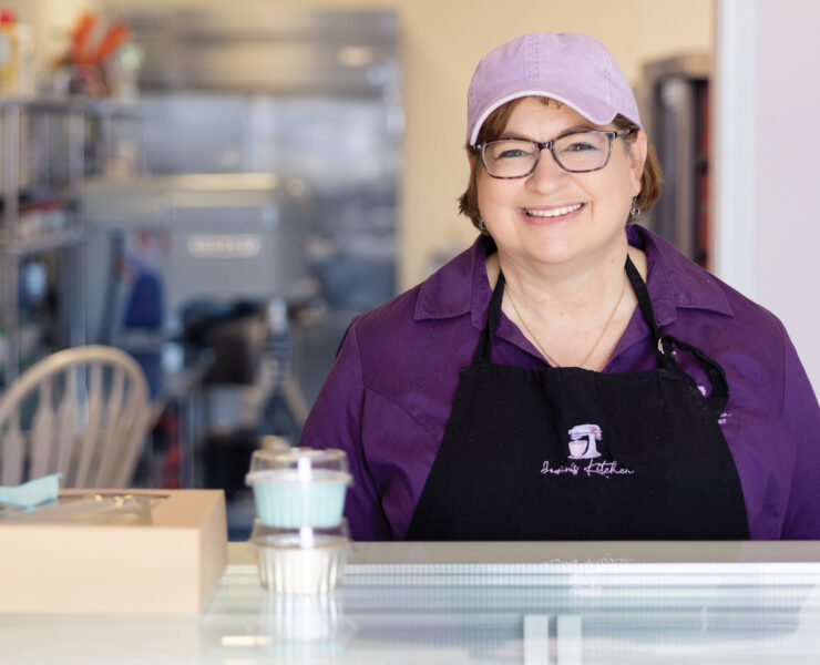 Featured Owner Of Jowins Jean Nicklas Poses Behind Counter