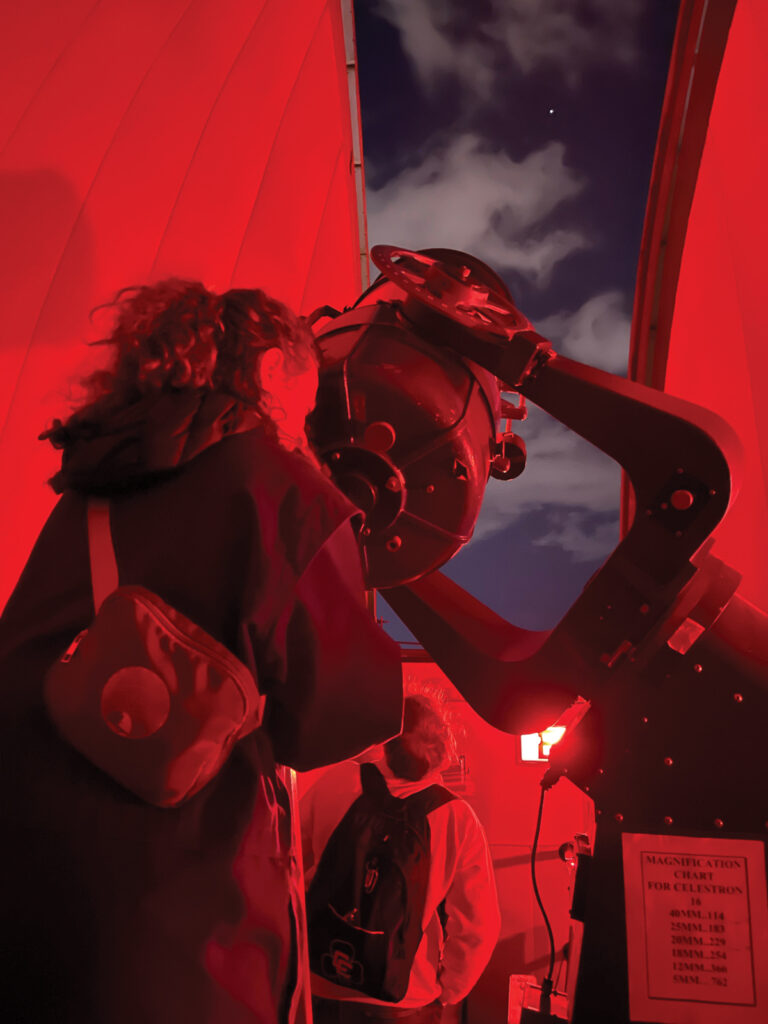 Looking Through A Telescope At An Observatory