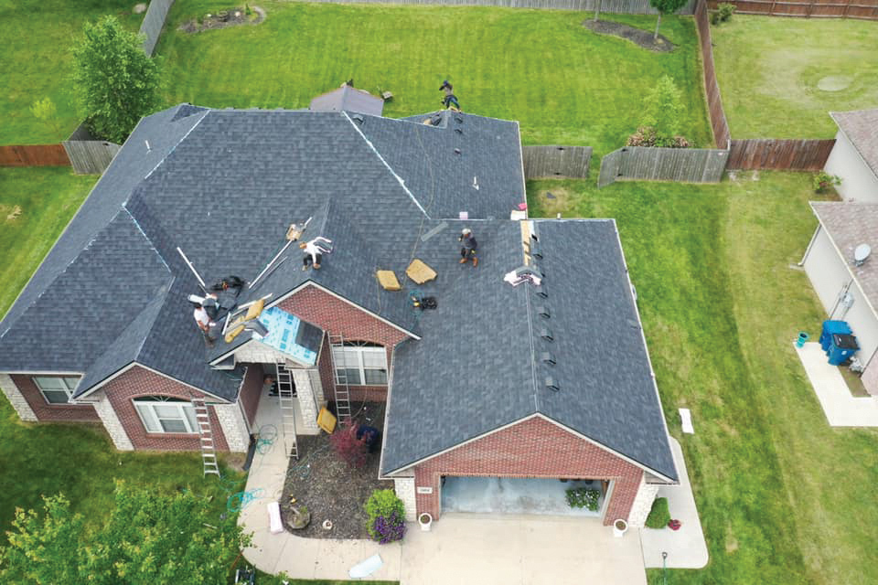 Overhead View Of Roofing Project With People