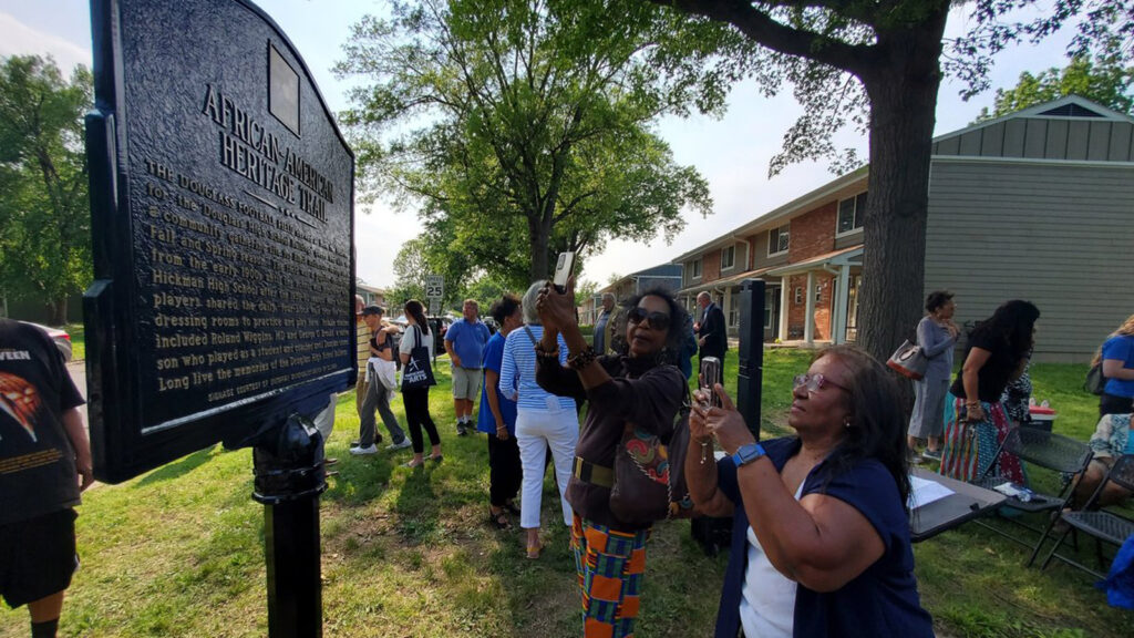 People take photos of a new marker on Columbia's African American Heritage Trail.