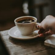 A hand serving coffee