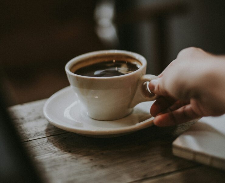 A hand serving coffee