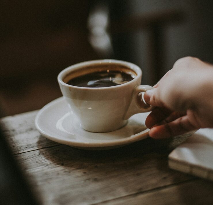 A hand serving coffee