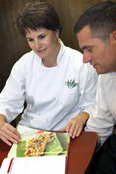 Central Methodist University Food Service Director Sharon Craven brainstorms with Fresh Ideas co-owner Matt Clervi on new menu ideas for preparing salmon at the university. Clervi recently flew to Alaska to ind a fresh, high-quality alternative to farm-raised salmon and halibut for his clients in the Midwest.