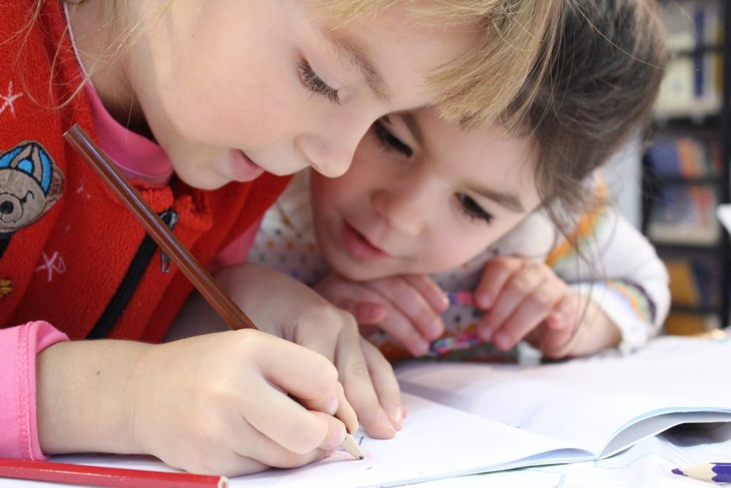 planting the seed of knowledge. One child is writing with a pencil
