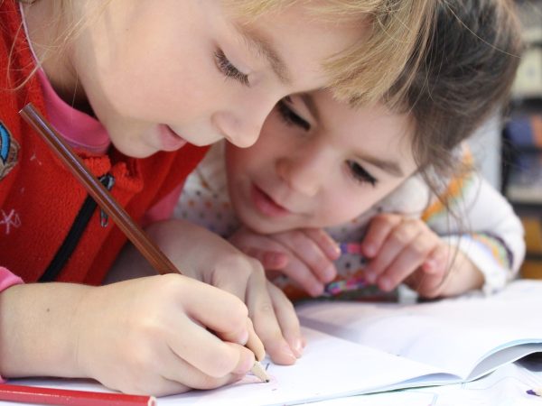 planting the seed of knowledge. One child is writing with a pencil