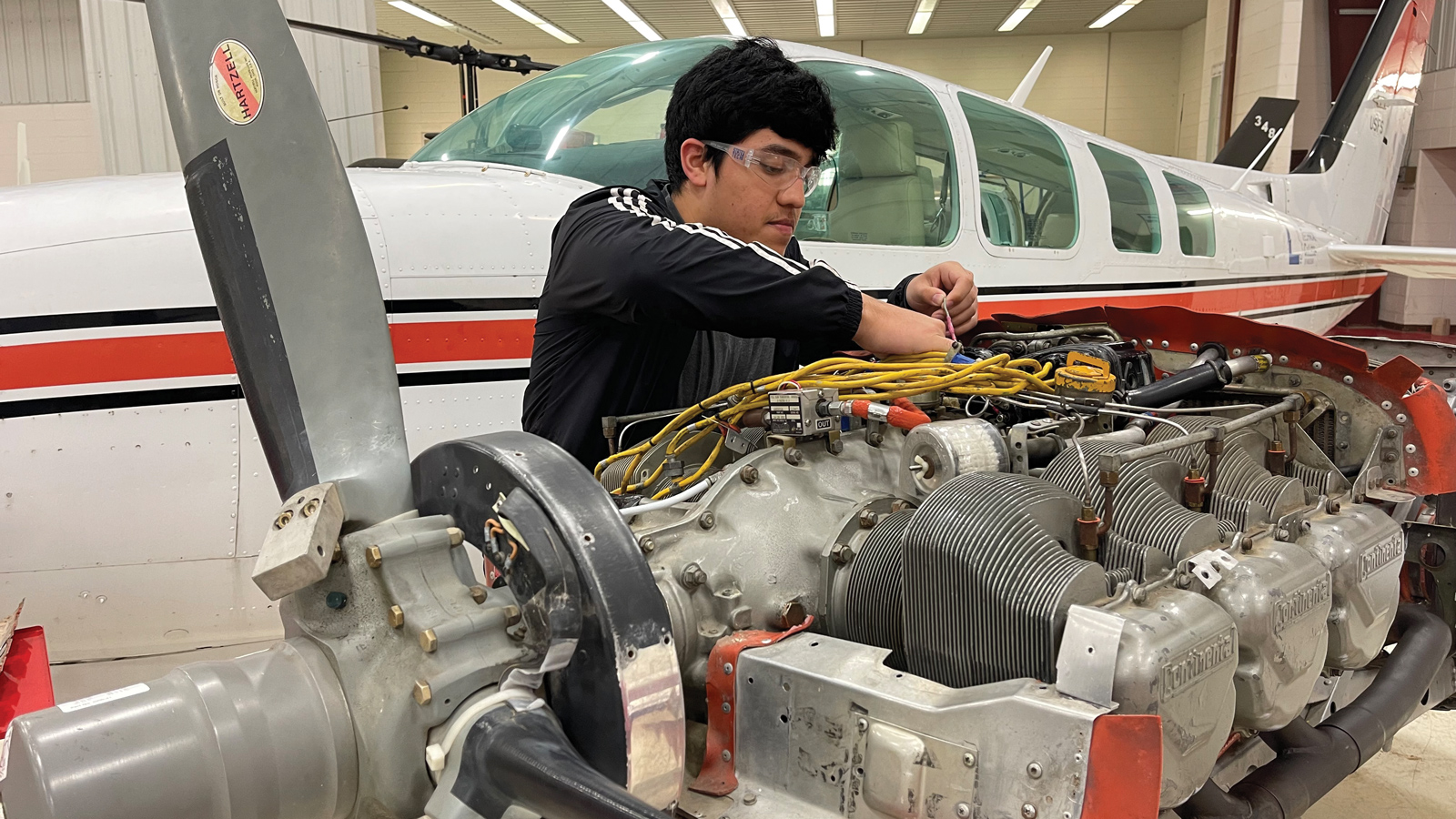 Featured State Tech Student Working On Airplane Mechanics