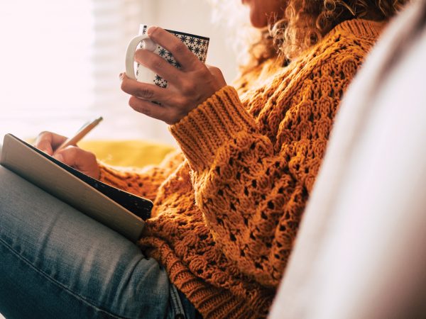 Featured Woman Writing In A Journal While Drinking Coffee