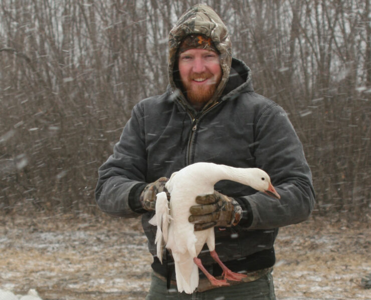 Featured Wildlife Biologist Craig Williamson Holding A Bird