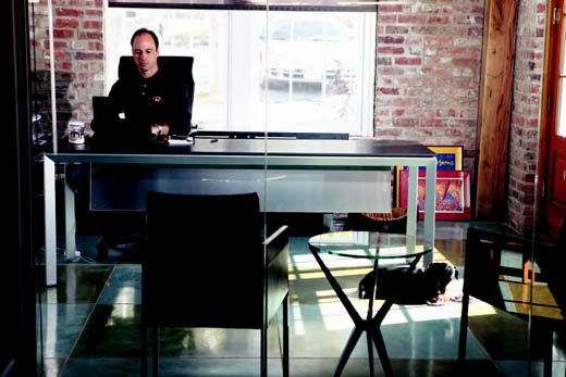 Terry Woodruff works in his office while his dog Nemo plays with a toy. Woodruff said the Fay Street Lofts building is an ideal work space. "We wanted to create a space that was very open and could nurture our mission statement of 'unexpected ideas nurtured in fresh air.'" Terry Woodruff works in his office while his dog Nemo plays with a toy. Woodruff said the Fay Street Lofts building is an ideal work space. "We wanted to create a space that was very open and could nurture our mission statement of 'unexpected ideas nurtured in fresh air.'"