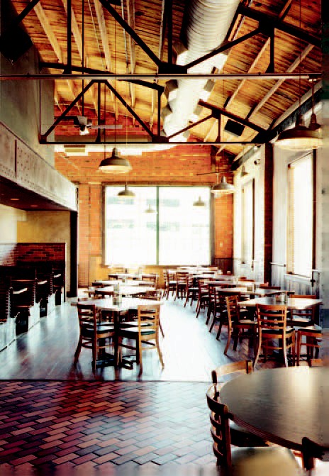 Coil renovated an existing auto repair building to create 7,500 square feet for Flat Branch Pub and Brewing, with details including a custom bar built from restored materials and new brewery systems.