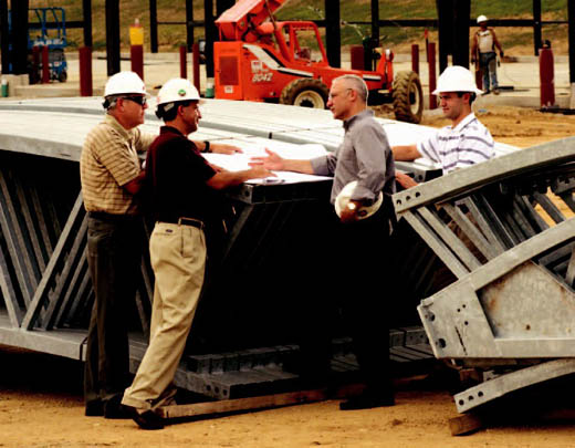 Kevin Buckler, Mike Hemme, Randy Coil and David Coil review drawings at the MoDot Maintenance Facility site.