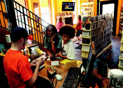 Anand Prahland and Eze Pojmann check out videos at Ninth Street Video.