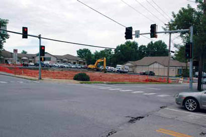 A backhoe clears the lot formerly occupied by Cleeks.