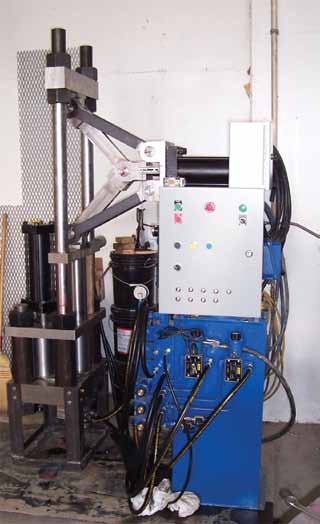This machine compacts biomass materials into energy tablets.