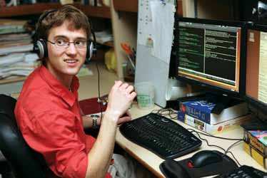 Brian Cooksey works remotely via Skype and Web cam with another Idea Works programmer working in Kansas City.
