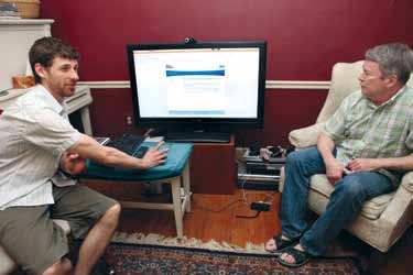 Chief of Operations Colin Monaghan discusses Web page design with Brent.