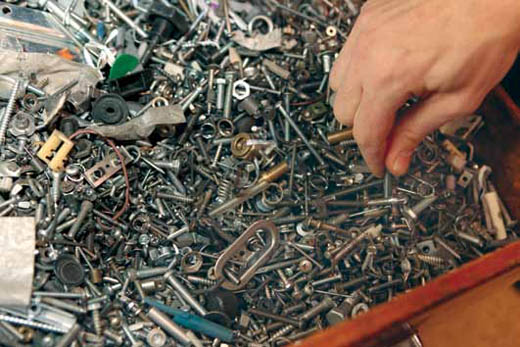 VanSickle sorts through a drawer of miscellaneous nuts and blots. VanSickle sorts through a drawer of miscellaneous nuts and blots.