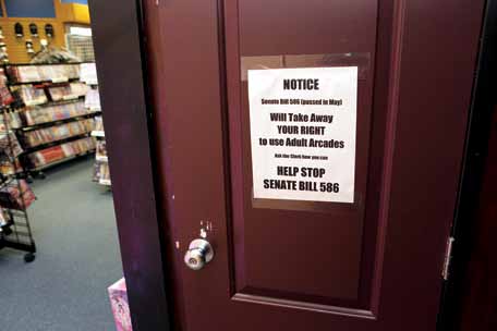 Doors to the private viewing booths at Passions inform customers of the new law that bans their use.