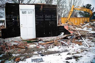 Workers began tearing down unoccupied homes Workers began tearing down unoccupied homes