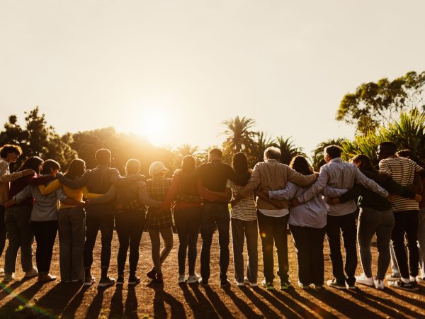 Back View Of Happy Multigenerational People Having Fun In A Public Park During Sunset Time Community And Support Concept