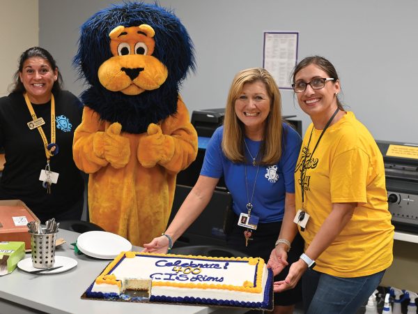 CIS employees and mascot celebrating the enrollment of its 400th student