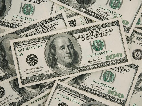 an assortment of $100 US bills overlapping one another