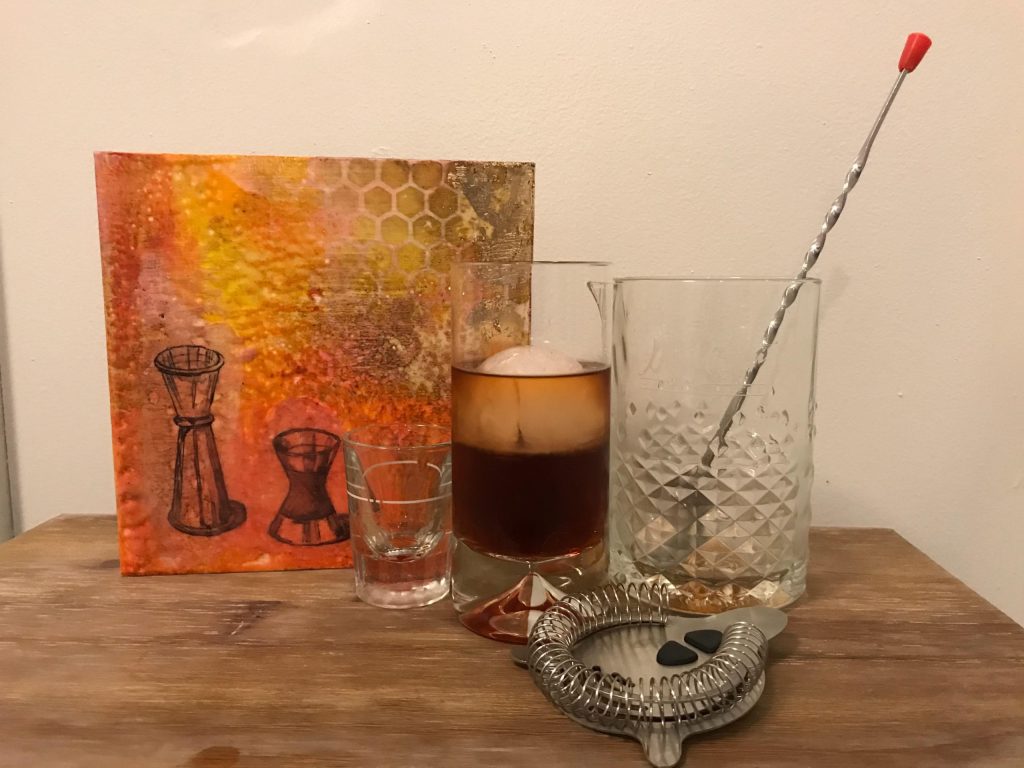 a mixing glass with a long spoon