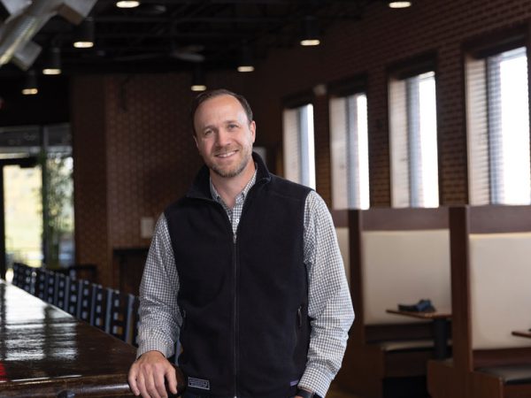 Headshot of a man named Matt Jenne standing in an empty resturant