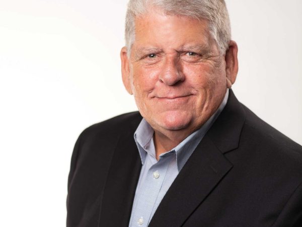 Headshot of a man in a suit named Randy Minchew against a white wall