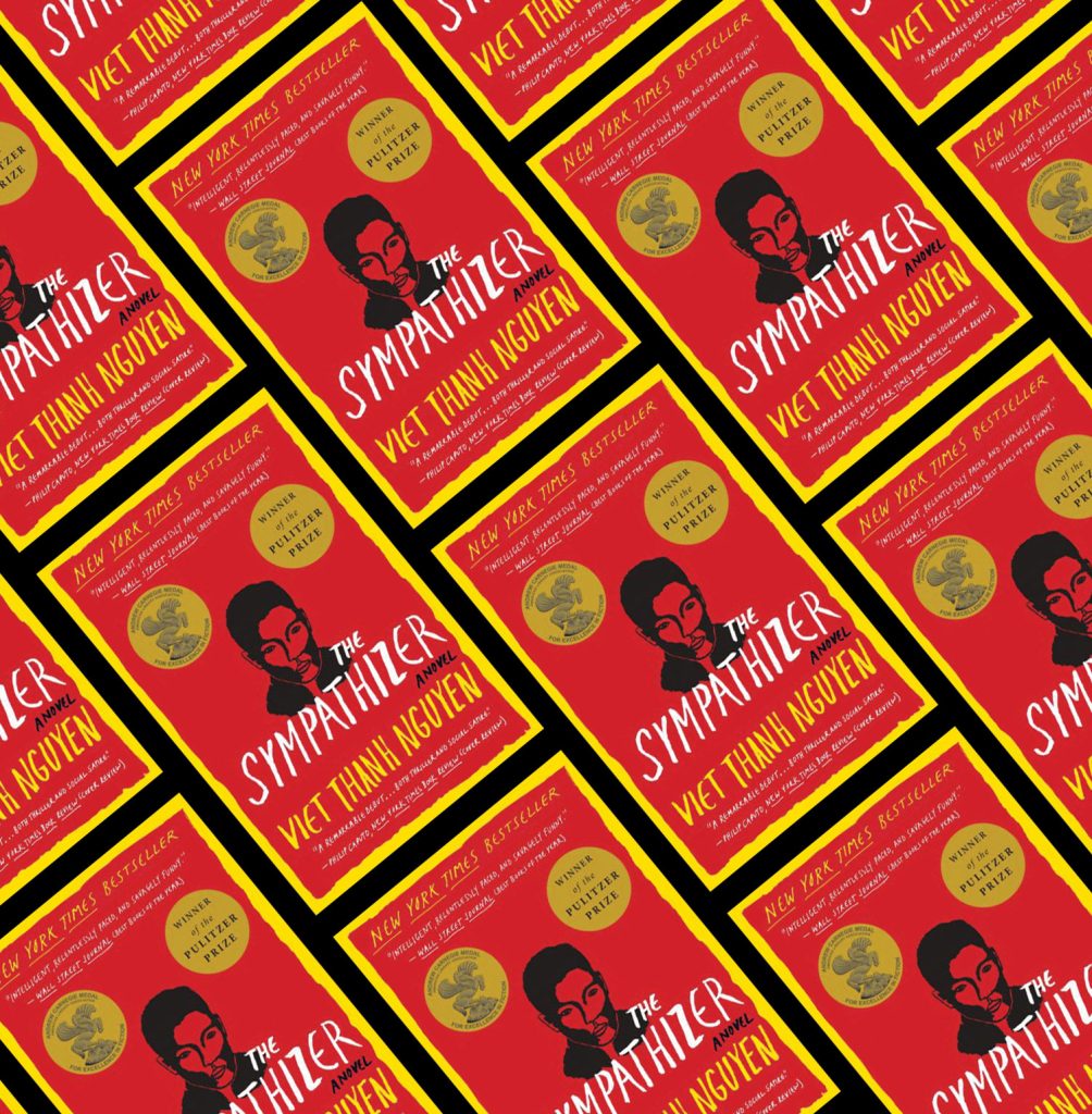 row and rows displayed at a angel of a red and yellow book with the title "The Sympathizer"