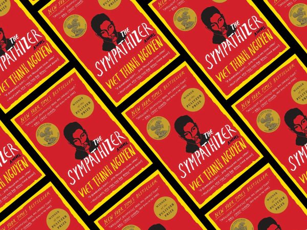 row and rows displayed at a angel of a red and yellow book with the title "The Sympathizer"