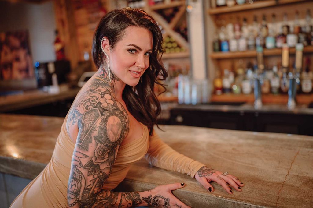 Headshot of a women named Amber Goodwin sitting at a bar