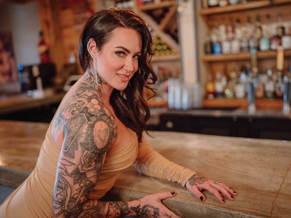 Headshot of a women named Amber Goodwin sitting at a bar