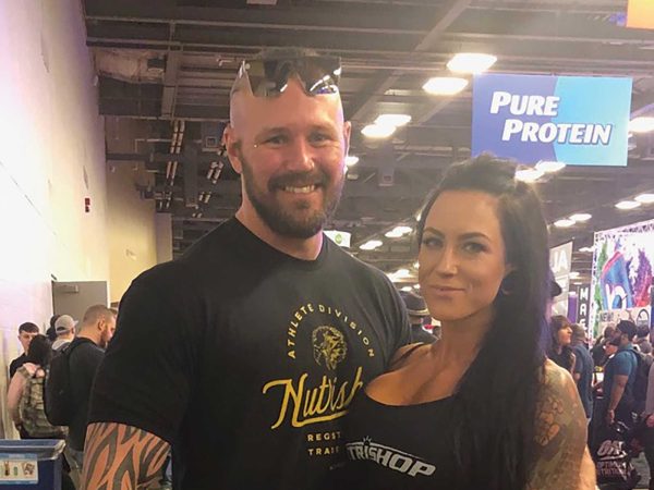while the woman has long dark hair and tattoos